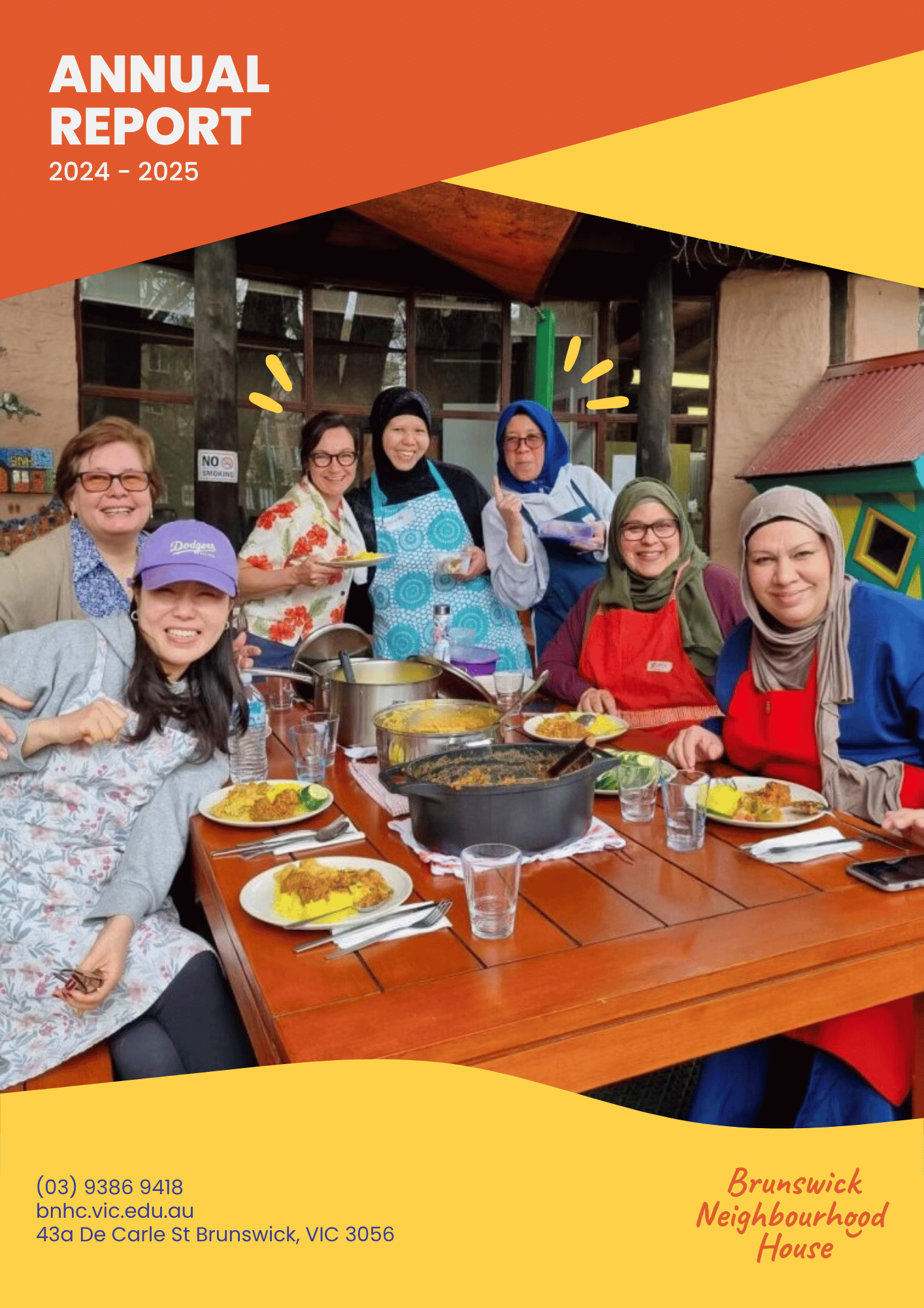 Group of women smiling  around a table of food