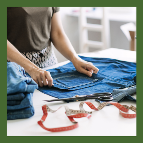 Person preparing to put a pocket on jeans